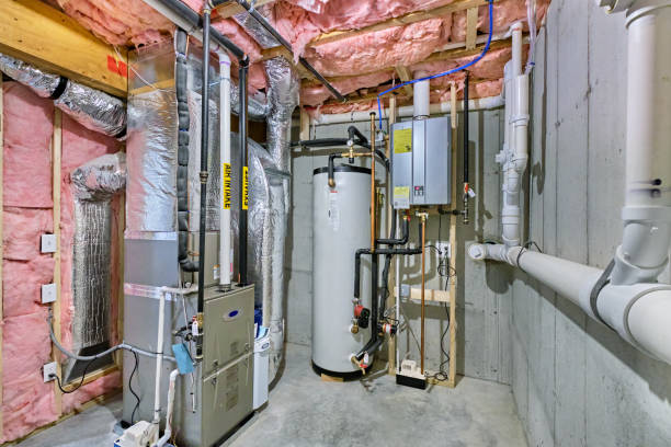 Unfinished basement mechanical room Unfinished basement mechanical room with tankless water heater, storage tank, plumbing and heating systems furnace stock pictures, royalty-free photos & images