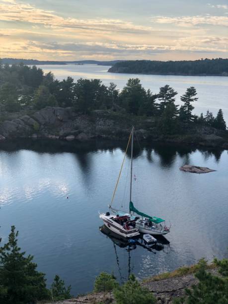 istock Sailboat  securely moored near a shoreline with a backdrop of trees providing a scenic view 1487524059