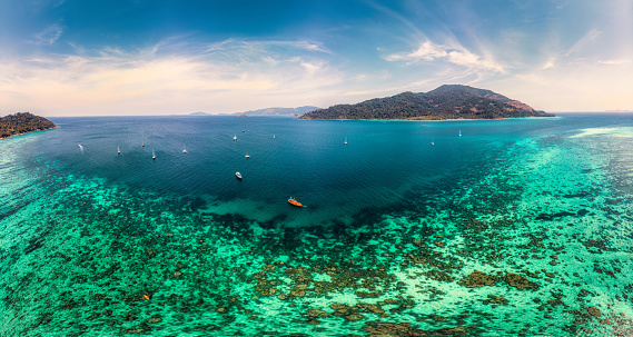 Panorama aerial view of beautiful tropical sea beach with emerald water and coral reef in summer on sunny day at Koh Lipe Island, Satun, Thailand