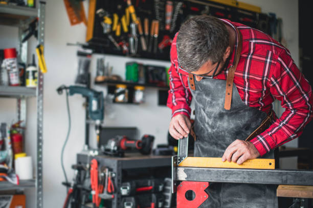 istock Craftsman in his workshop measuring a metal rod for cutting 1487531281