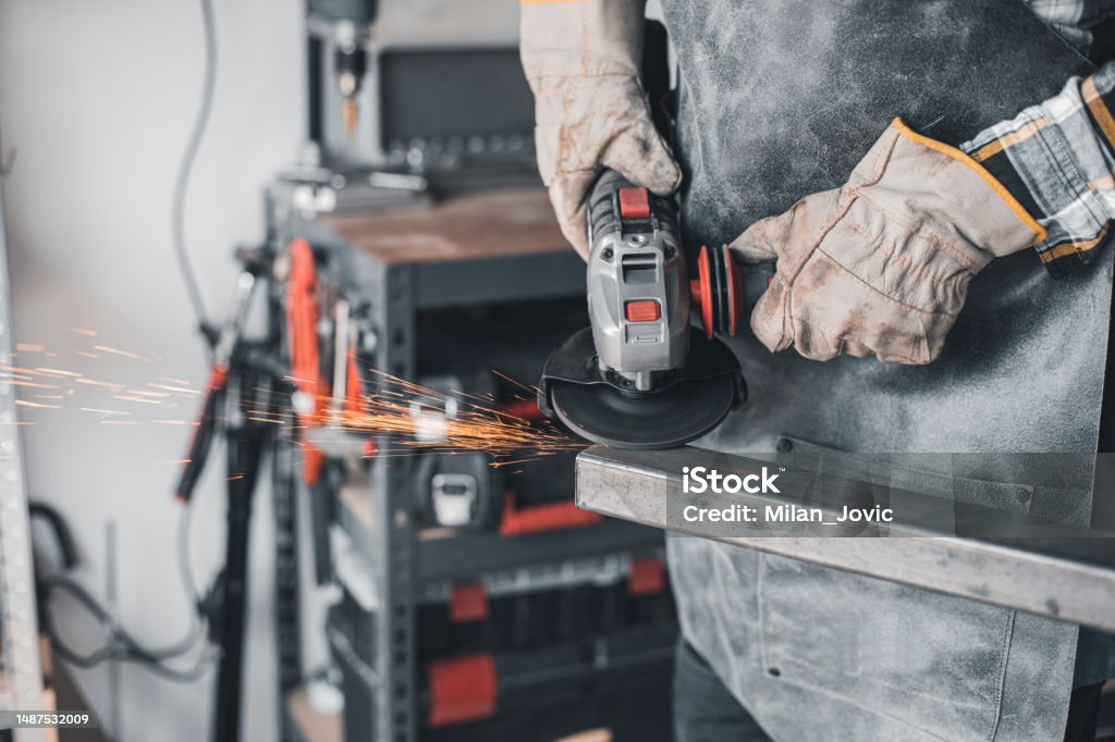 Using Grfinder Close Up Of Craftsmans Hands Cutting Metal And Using Angle Grinder In ...