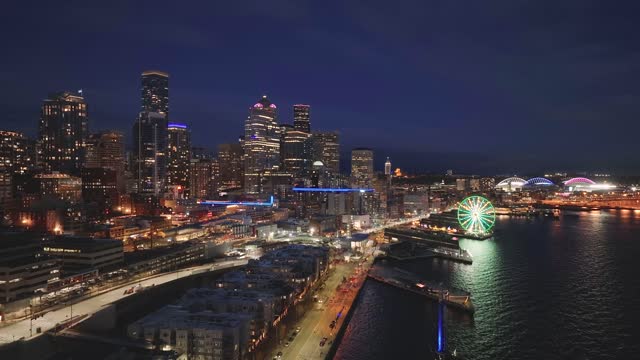 Seattle waterfront with pier, restaurant and Business skyscraper building during twilight time in Washington, USA.