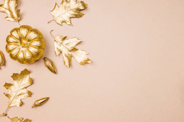 istock Template with Fall decor in golden colors and empty space. Gold painted leaves, pumpkins and acorns, autumn season 1487534640