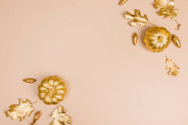 istock Fall decor in golden colors with empty space for text. Gold painted leaves, pumpkins and acorns, autumn season 1487534656