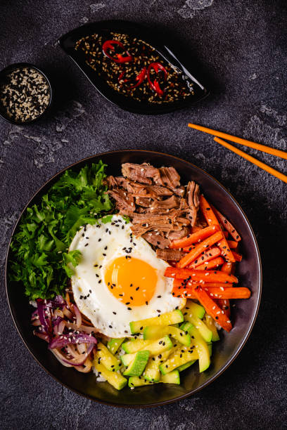 istock Traditional Korean dish Bibimbap: rice with vegetables beef and egg. 1487535641