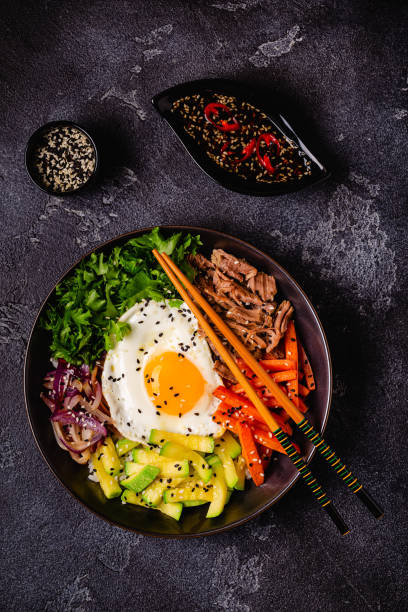 istock Traditional Korean dish Bibimbap: rice with vegetables beef and egg. 1487535779