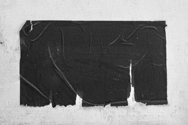 istock Torn black street poster closeup. 1487536261
