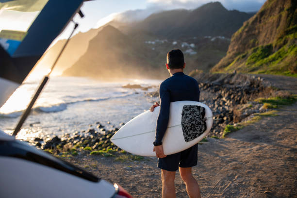 istock A middle aged surfer looks out towards the beach. 1487540439