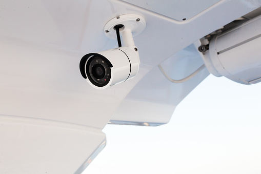istock CCTV camera on the hull of an expensive motor yacht. CCTV camera white on a white body. 1487540717