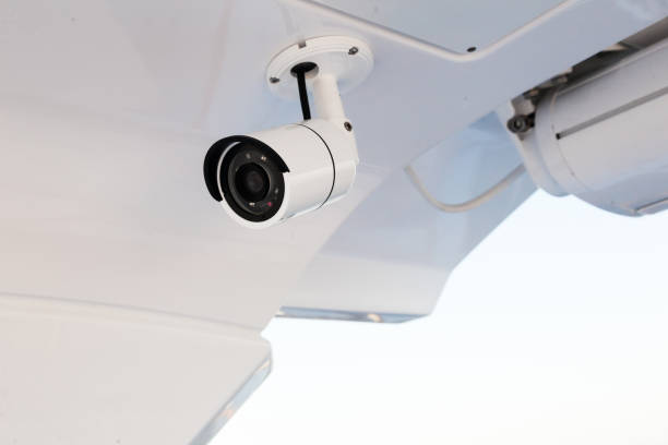 CCTV camera on the hull of an expensive motor yacht. CCTV camera white on a white body. CCTV camera on the hull of an expensive motor yacht. CCTV camera white on a white body. hull house stock pictures, royalty-free photos & images