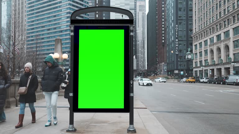 Green wrinkled poster template in city. Glued paper mockup. Blank wheatpaste on textured wall. Empty street art sticker mock up. Billboard advertisment advertiser in Chicago, Illinois, USA