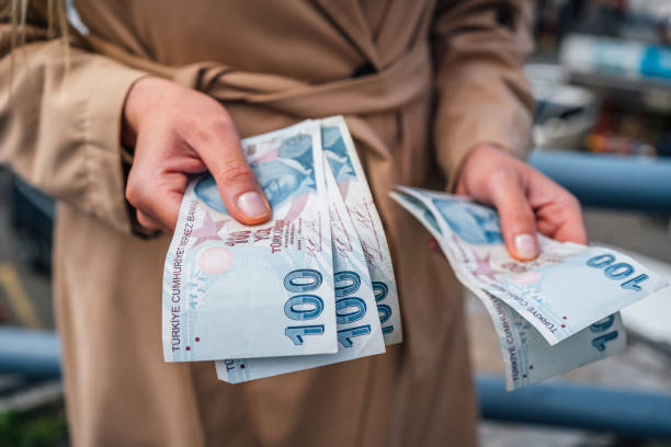 Woman counting Turkish lira in the street of Istanbul stock photo