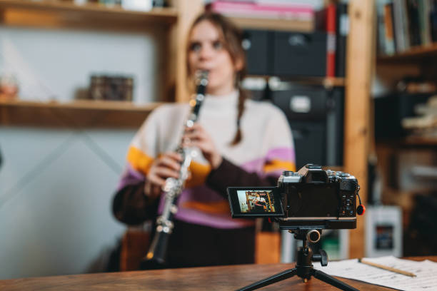 istock A musician is recording a video while she's playing clarinet 1487545564