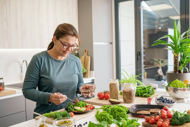 istock Woman adding quinoa to a plant-based meal 1487545857