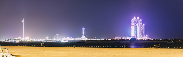 Panoramic view of illuminated skyscrapers in Abu Dhabi, United Arab Emirates