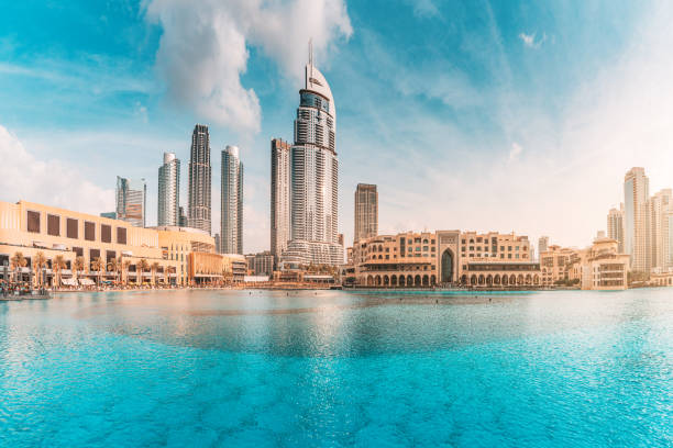Water pond near the entrance to Dubai Mall and on promenade embankment with skyscrapers in the background stock photo