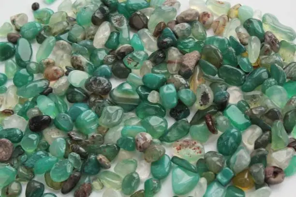 Close-up of green aventurine semi-precious natural polished gemstone mineral rock. Heart Chakra healing crystals. quartz chrysoprase pebbles. Meditation and esoteric life balance concept