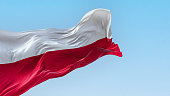 The national flag of Poland waving in the wind on a clear day