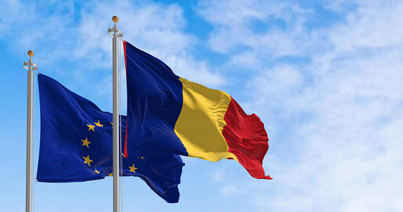 Romania and European Union flags waving in the wind on a clear day. Eu member since January 2007. 3d illustration render. Fluttering fabric