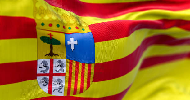 istock The Aragon flag waving. Aragon is an autonomous community in northeastern Spain. Selective focus. 3d illustration render. Close-up. Textured background 1487554255