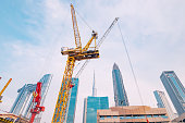 construction site with crane machinery against background with Dubai skyscrapers