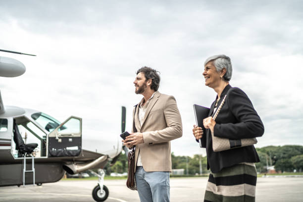 istock Coworkers looking around while walk in the airport hangar 1487558830