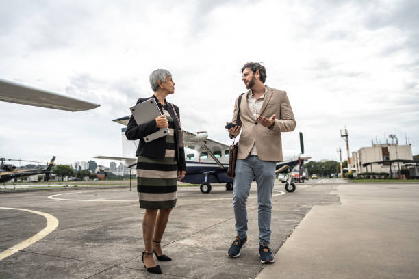 istock Coworkers talking while walk in the airport hangar 1487558855