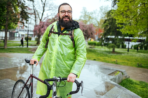 Portrait of a man with a bicycle in the park