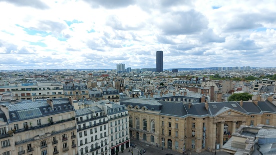 Montparnasse Tower and Madeleine Church in a stormy weather in Paris in summer