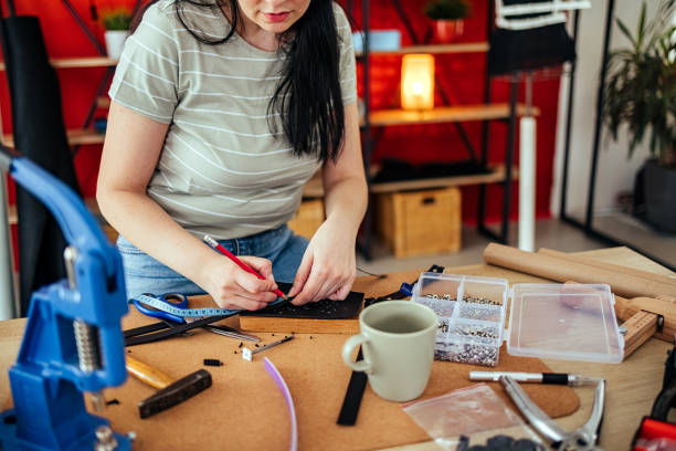 istock Woman makes a leather belt 1487561914