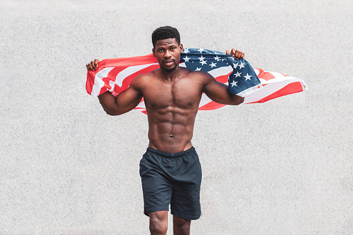 African american guy with usa flag protests and shouts, patriot activist. Copy space.