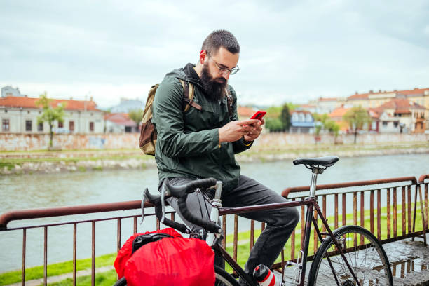 istock Cyclist uses a mobile phone 1487562284