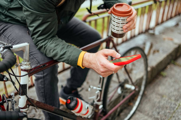 istock Cyclist uses a mobile phone 1487562381