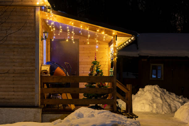 istock Christmas tree by wooden house 1487565609