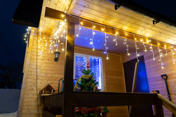 istock Christmas tree by wooden house 1487565611