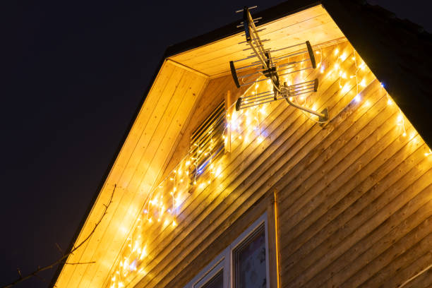 istock Christmas lights on wooden house at night 1487565613