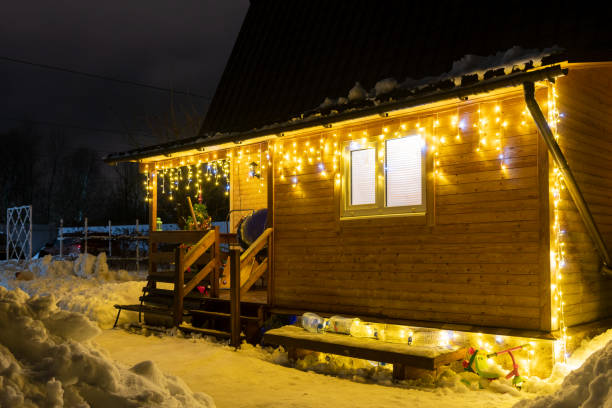 istock Christmas lights on wooden house at night 1487565743