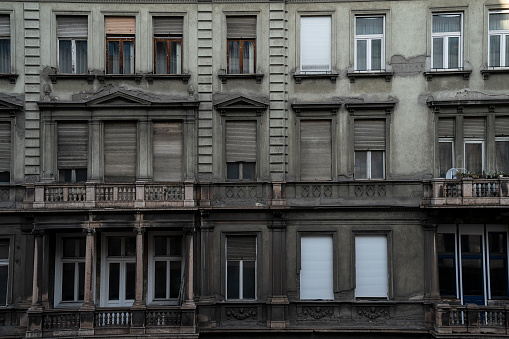 Budapest, Hungary - November 25th, 2022: A typical neglected building facade in the historic part of Budapest.