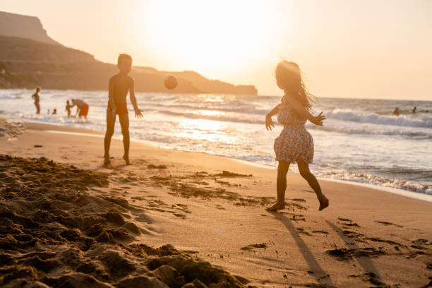 istock Children playing with ball on the beach 1487567561