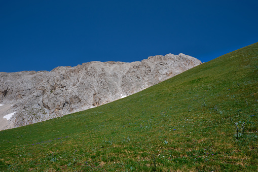meadow and mountainous contrast of the summit of the gran sasso abruzzo