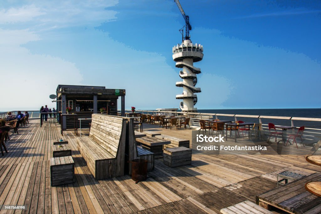 Scheveningen Pier And Amazing View Onfirst Days Of Summer With Man In  Hydrocostume In Water And Blonde Youngwoman On Piers Stock Photo - Download  Image Now - iStock