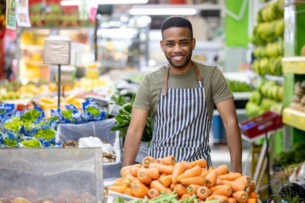 istock Happy retail clerk working at a supermarket 1487569778