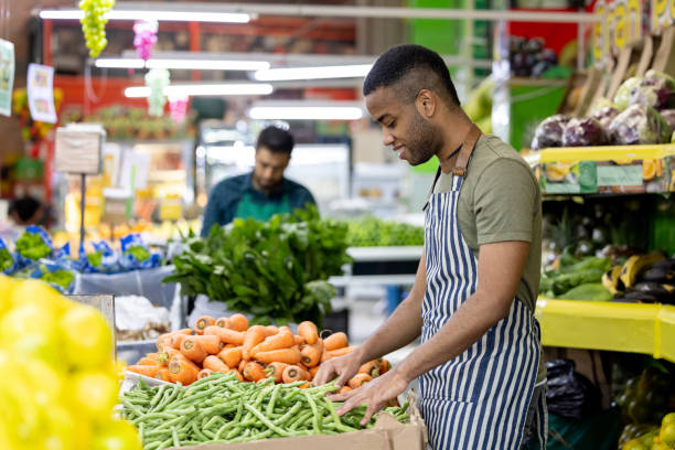istock Man working at a greengrocer's shop 1487569789