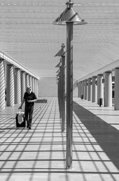 istock Front View Of Man Walking With Bag At Arcade 1487569894