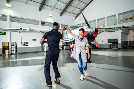 Airplane mechanics dancing in the airport hangar
