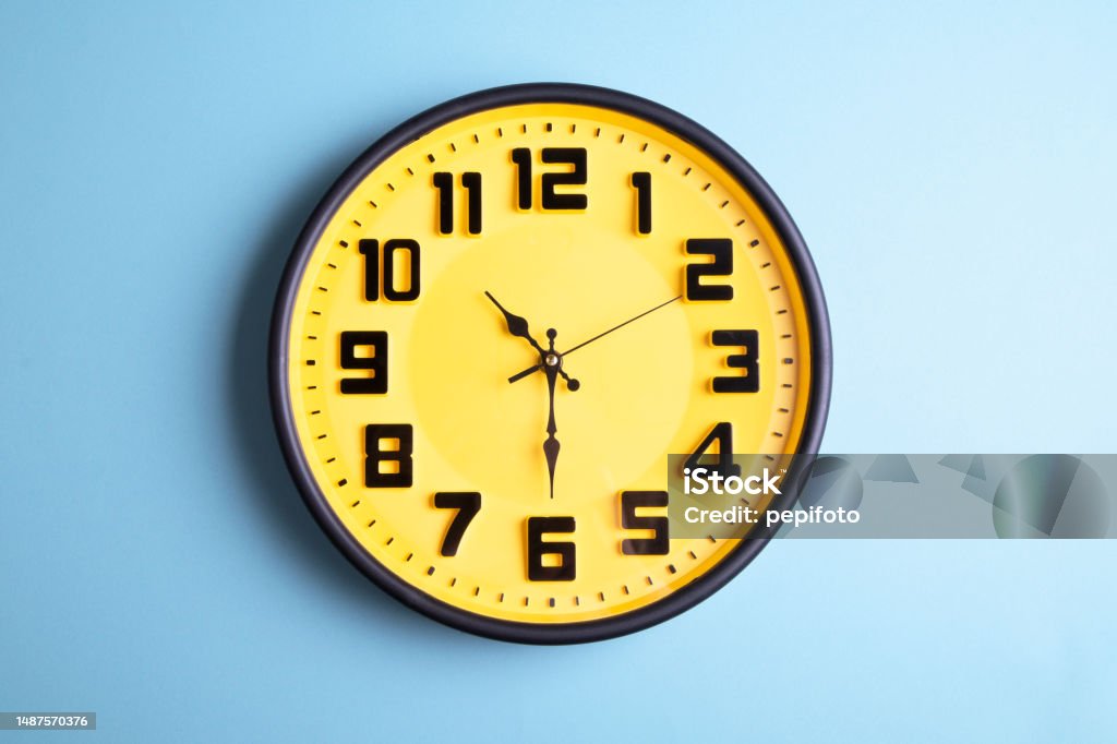 Clock on blue background Time Clock Stock Photo