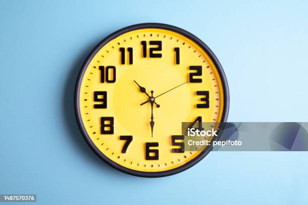 Clock On Blue Background Stock Photo - Download Image Now - Time Clock, Domestic Life, Yellow