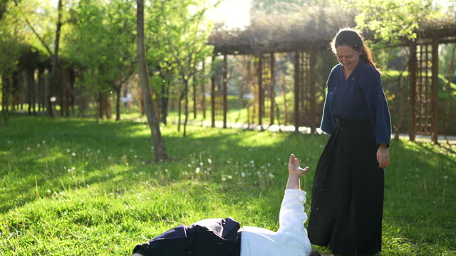 Aikido couple participants of the training in special clothes of aikido at outdoor