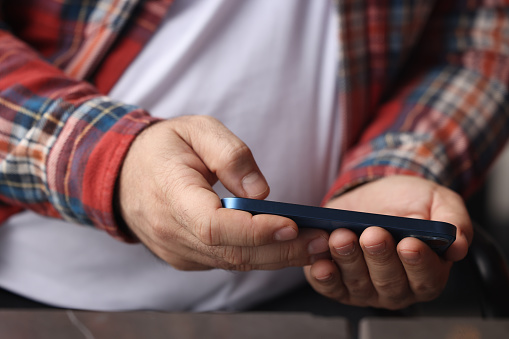 Man using smart phone in cafe