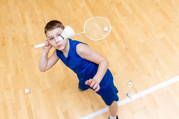 Kid playing badminton. Horizontal sport theme poster, greeting cards, headers, website and app Kid playing badminton. Horizontal sport theme poster, greeting cards, headers, website and app racket sport stock pictures, royalty-free photos & images
